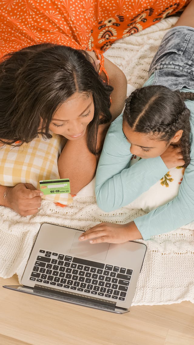 A mother shops online with her daughter
