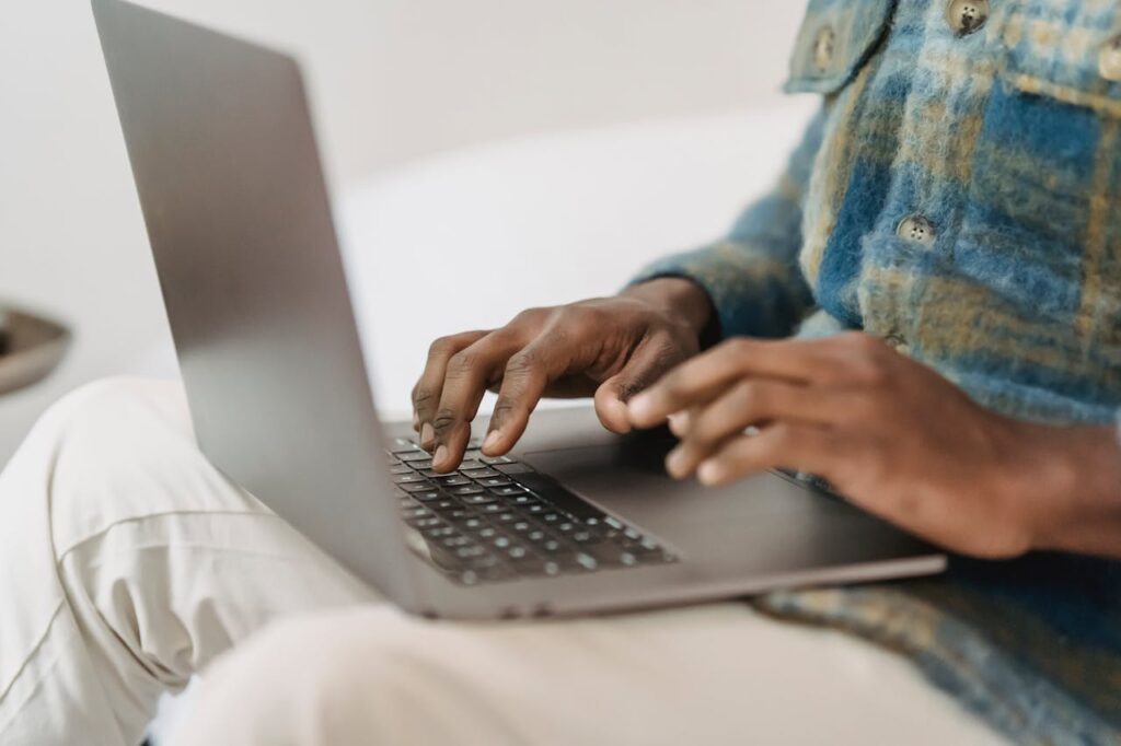 Person enters information on their laptop
