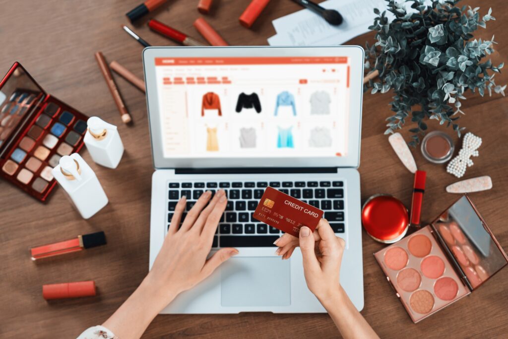 A woman holding a credit card while shopping through small business e-commerce