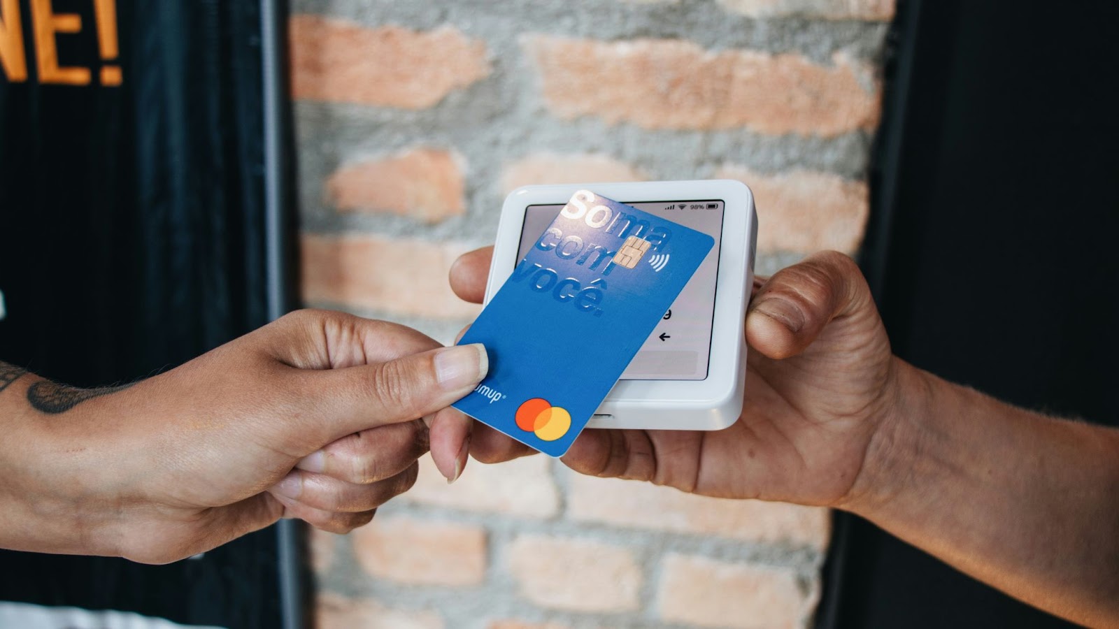 Hands holding a machine and using AI in payments